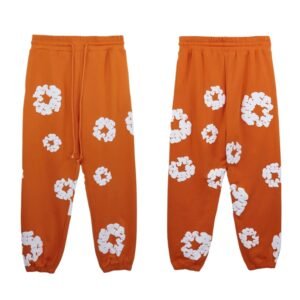 Orange sweatpants with DENIM TEARS print